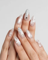 Snowfall handmade press-on nails featuring pearl nude cat eye snowflake bow silver glitter soft sheen