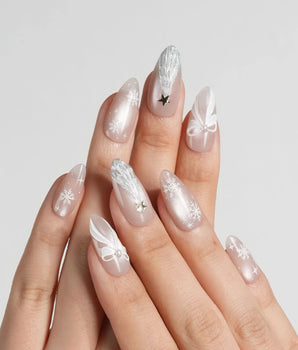 Snowfall handmade press-on nails featuring pearl nude cat eye snowflake bow silver glitter soft sheen