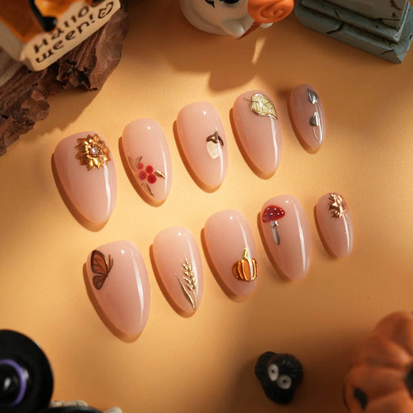 Nude fall nails with pumpkin accent