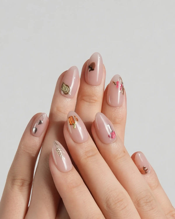 Extra short almond nude nails with leaf design