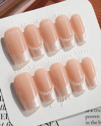 Dew Sparkle in medium square shape with pearly French tips and polished nude gel