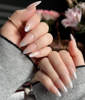 Your Glow press-on nails with nude cat-eye French tips and fine metallic gold linework