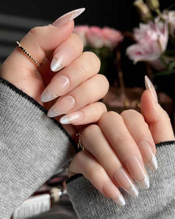 Your Glow press-on nails with nude cat-eye French tips and fine metallic gold linework