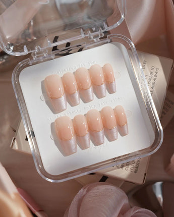 Your Glow in medium coffin shape with cat-eye nude French tips and delicate gold wire