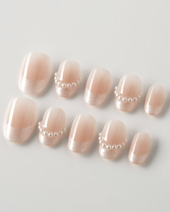 Dew Sparkle in extra short oval shape with nude French tips and pearly silk texture