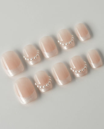 Dew Sparkle in extra short squoval shape with pearly French tips and soft nude color