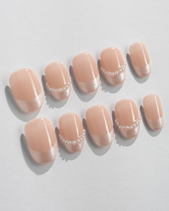 Dew Sparkle in short oval shape with pearly nude French design and glossy gel finish
