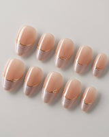 Your Glow in extra short almond shape with nude cat-eye French tips and gold accents