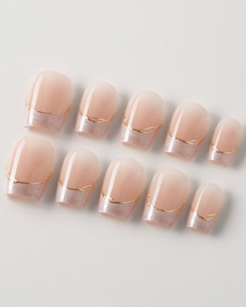 Your Glow in extra short coffin shape with nude French tips and subtle gold accents