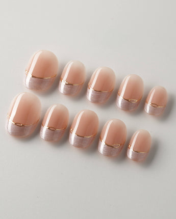 Your Glow in extra short oval shape with nude French tips and soft metallic shimmer