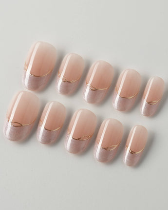 Your Glow in short oval shape with soft nude French tips and fine metallic gold linework