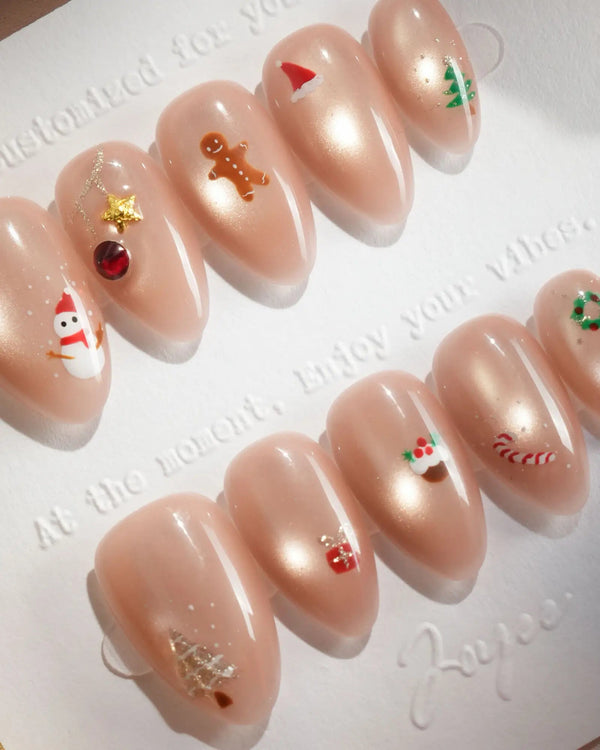 Nude Christmas press-on nails with mini festive icons