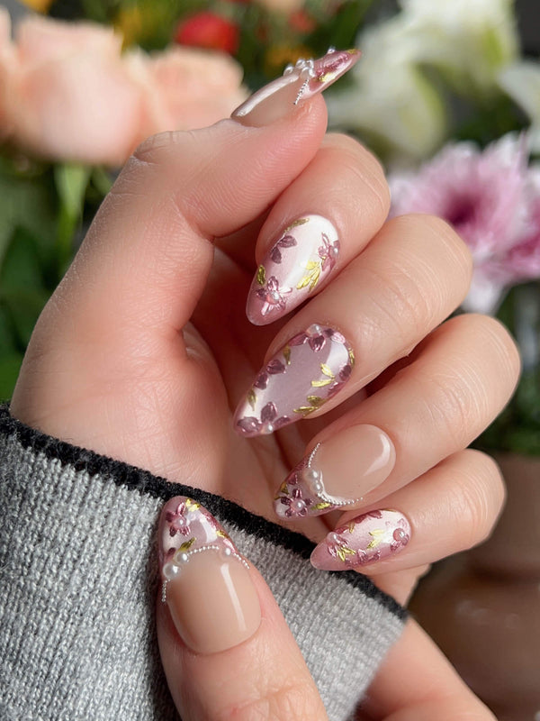 Nude pink nails with hand-painted sakura petals and pearl French line	