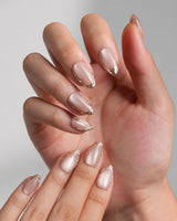 Nude Spark press-on nails in extra short almond shape — Premium Champagne Cat Eye, Irregular French Metal Outlines.