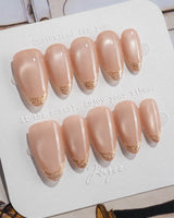 Nude Spark press-on nails in short almond shape — Premium Champagne Cat Eye, Irregular French Metal Outlines.