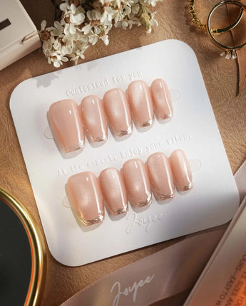 Nude Spark press-on nails in short coffin shape — Premium Champagne Cat Eye, Irregular French Metal Outlines.