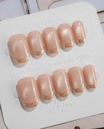 Nude Spark press-on nails in short oval shape — Premium Champagne Cat Eye, Irregular French Metal Outlines.