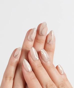 Oat Latte press-on nails in extra short almond shape — Sheer Nude Skin, Minimalist Silver Glitter Swirls.