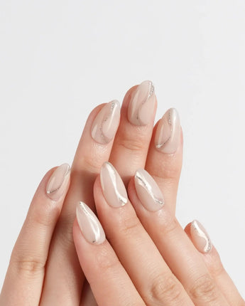 Oat Latte press-on nails in extra short almond shape — Sheer Nude Skin, Minimalist Silver Glitter Swirls.