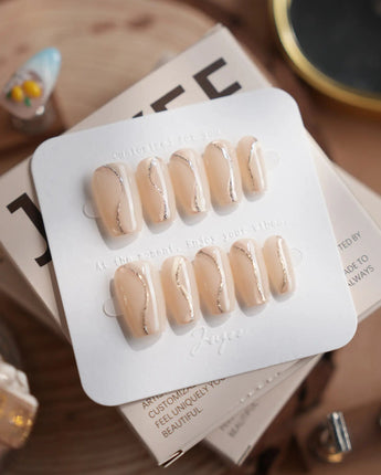 Oat Latte press-on nails in short coffin shape — Sheer Nude Skin, Minimalist Silver Glitter Swirls.