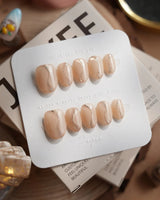 Oat Latte press-on nails in short oval shape — Sheer Nude Skin, Minimalist Silver Glitter Swirls.