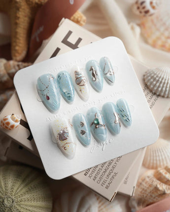 Ocean Heart muted grey-blue nails with metallic fish, coral and pearl bubbles