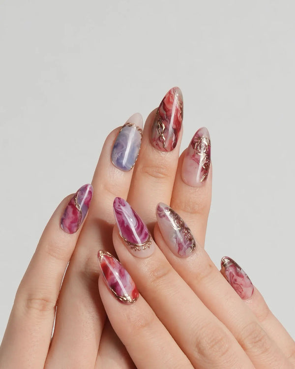 Oil-paint swirl nails in red, pink, and blue