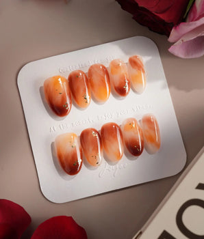Onyx Shine nail set with warm amber marble design and hand-painted glossy gel depth