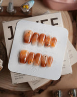 Onyx Shine in short coffin shape with amber marble effect and deep glossy finish