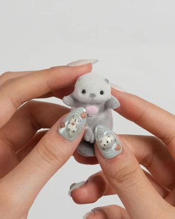 Otter Momo extra short almond nails with otter charm and translucent wave design