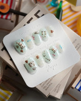 Otter Momo extra short oval nails with mint jelly waves and 3D otter accents