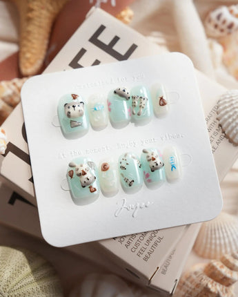 Otter Momo extra short square nails with otter charm and translucent ocean texture