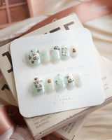 Otter Momo extra short squoval nails with 3D otters and mint cream ripples
