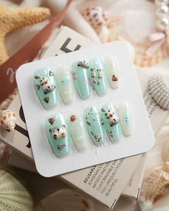 Otter Momo medium coffin nails with sculpted otters, starfish, and watery shine