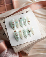 Otter Momo medium stiletto nails with sculpted otter art and floating-water texture