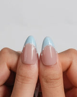 Oyster Blue glossy nude nails with clean blue French tips and coastal pearl details