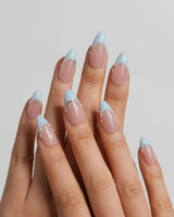 Oyster Blue coastal French nails with warm nude base, tiny pearls, and soft blue tips