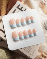 Oyster Blue short square nails with pearl-lined French tips and silver starfish charm
