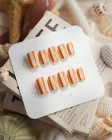 Parasol extra short coffin press-on nails with clean tangerine vertical stripes