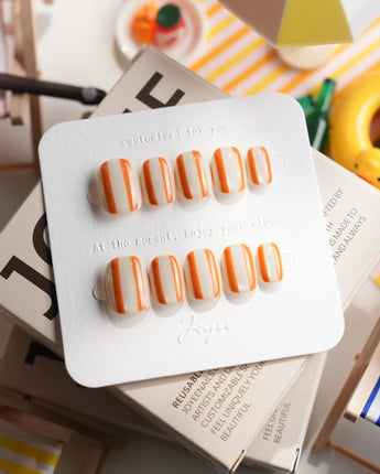 Parasol extra short squoval press-on nails with retro tangerine stripe design