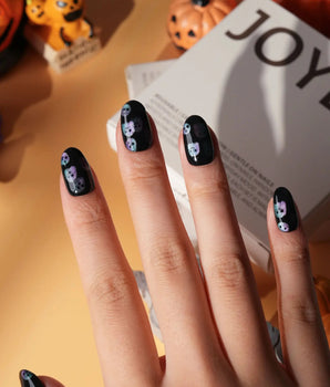 Party Spirits press on nails with holographic teal, lilac and pink glitter ghosts on a glossy black base - image 1