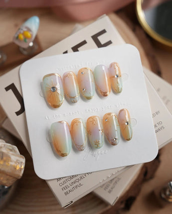 Pastel Relic in medium oval shape with champagne shimmer and gold starburst accents