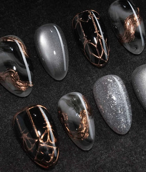 Patina press on nails with copper brushwork over black and grey smoke marble, silver grey cat eye and a copper gothic arch on black - image 1