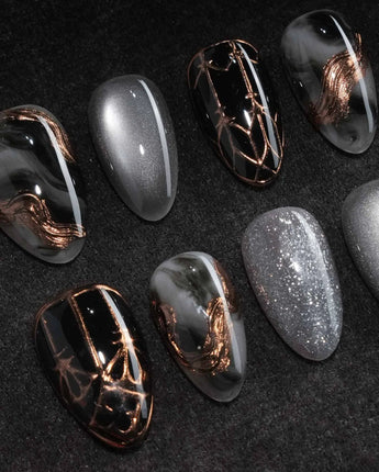 Patina press on nails with copper brushwork over black and grey smoke marble, silver grey cat eye and a copper gothic arch on black - image 1