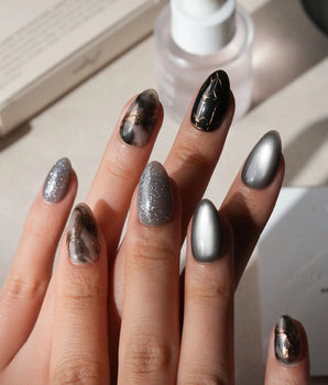 Patina press on nails with copper brushwork over black and grey smoke marble, silver grey cat eye and a copper gothic arch on black - image 2