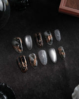 Patina press on nails with copper brushwork over black and grey smoke marble, silver grey cat eye and a copper gothic arch on black - image 3