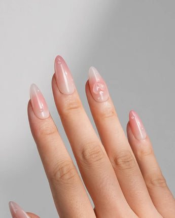 Peach Dew custom-size almond nails with peach dewdrops and tender nude tones
