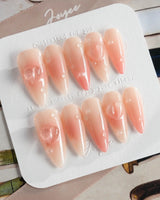 Peach Dew medium almond nails with translucent peach art and soft glossy finish
