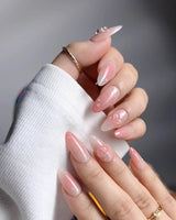 Peach Dew summer nail set with nude-to-peach gradient and glossy droplets