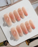 Peach Dew tender peach nails with nude base, glossy gel, and dewdrop accents